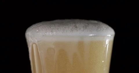 Smooth Slow Motion of Beer Foam and Bubbles Dancing in a Glass Stock Footage 340078854