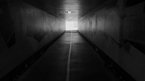 Smooth slowmotion walking through an urban tunnel in Brisbane city in B &amp; W. Stock Footage 267933451