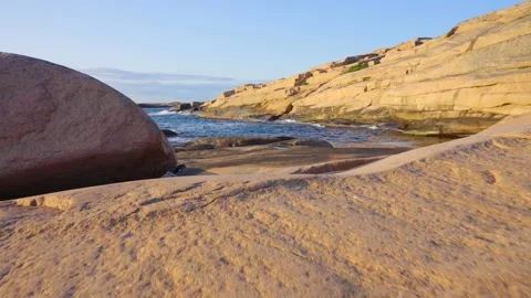 Smooth solid granite flat bedrock and walls on coast. blue ocean sunny evening Stock Footage 163239270
