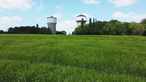 A smooth span overlooking two water towers, against a backdrop of green. Stock Footage 287094424