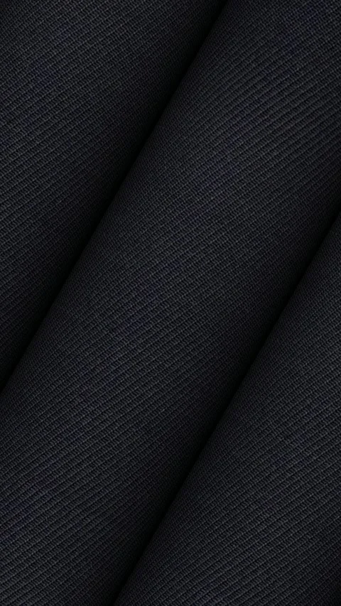 Smooth spinning rolls of Italian deep black solid wool suiting fabric 스톡 동영상 343211763
