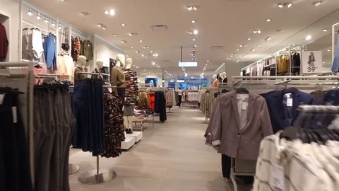 Smooth steadicam shot through fashion clothing store Stock Footage