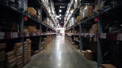 Smooth &amp; steady slow motion shot inside giant warehouse aisle Video stock 79891436