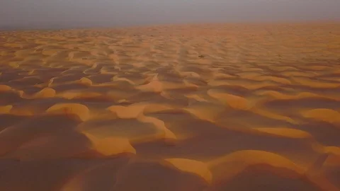 Smooth straight low altitude flight across beautifully layered sand dunes Stock Footage 90235817