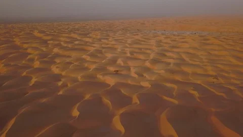Smooth straight low altitude flight across beautifully layered sand dunes Stock Footage 90235987