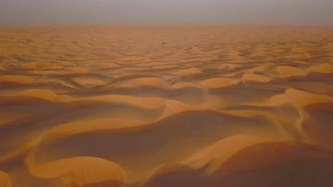 Smooth straight low altitude flight across beautifully layered sand dunes Stock Footage 90256505