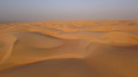 Smooth straight low altitude flight across beautifully layered sand dunes Stock Footage 90260001