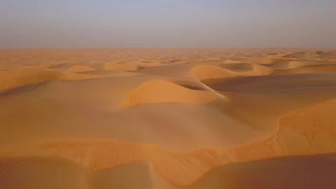 Smooth straight low altitude flight across beautifully layered sand dunes Stock Footage 90260747