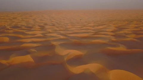 Smooth straight low altitude flight across beautifully layered sand dunes Stock Footage 90264039