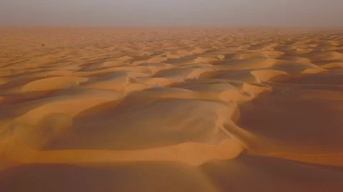 Smooth straight low altitude flight across beautifully layered sand dunes Stock Footage 90264051