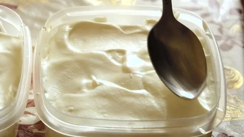 Smooth the surface of the dough with a spoon Stock Footage 245540580