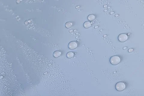 A smooth surface of light blue color covered with water droplets, a beautiful Stock Photos