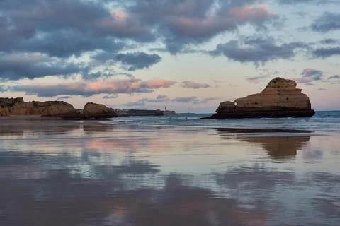 Smooth surface of the ocean beach during the low tide. Portimao, Portugal Stock Photos