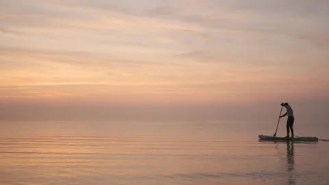 Smooth surface of water in mist against background of sunrise. Stock Footage 244606312