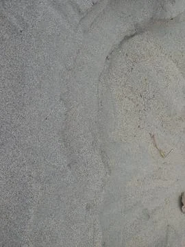 Smooth, textured gray sand surface with subtle wave patterns and natural organic Stock Photos