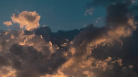 A smooth time lapse of a dramatic sunset, colorful surfing clouds, teal Stock Footage 271318677