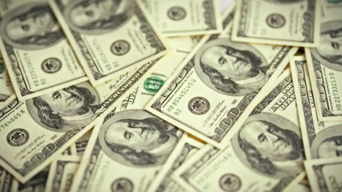 A smooth top-down sweep over a spread of vintage dollar bills highlights a p Stock Footage 336570331