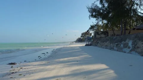 Smooth tracking shot travelling down a perfect sandy beach paradise Stock Footage 148531805
