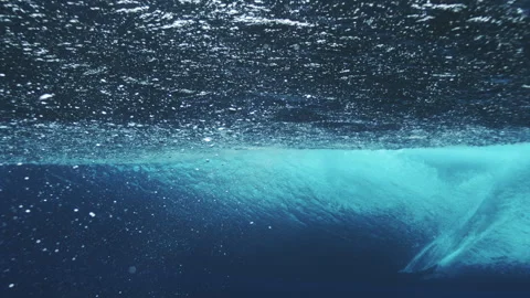Smooth Underwater Barrel Wave Forming a Blue Arc Stock Footage 328895705