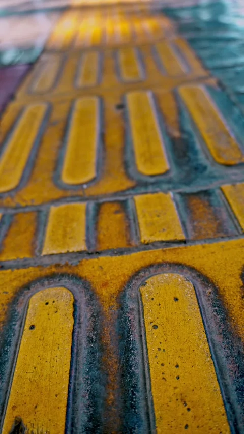 Smooth upward vertical tilt camera movement revealing tactile paving tiles .. Stock Footage 342035554