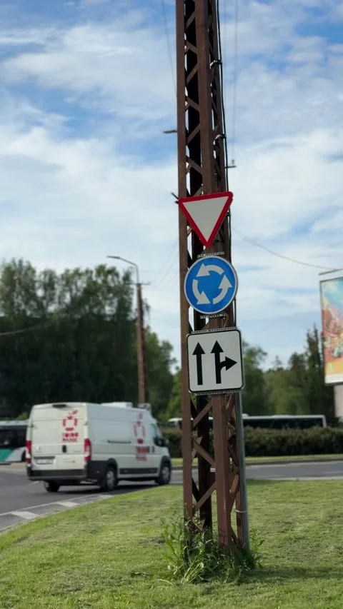 A smooth vertical shot of roundabout road signs, blurred background, zoom in Stock Footage 310383597