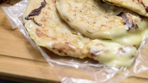 A smooth video pan showcasing cheese-filled pupusas with curtido and sauce .. 動画素材 294112946