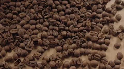 Smooth view of bunch of roasted coffee beans being poured into small pile. Stock Footage 171638309