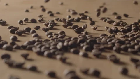 Smooth view of bunch of roasted coffee beans being poured into small pile. Stock Footage 171638892