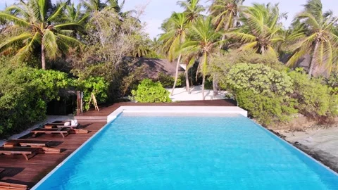 Smooth view of tropical paradise, pool and palm beach on Maldives island Stock Footage 154365522