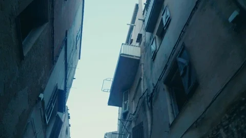 Smooth walking shot tilted up in old street in southern european village Stock Footage 88903429