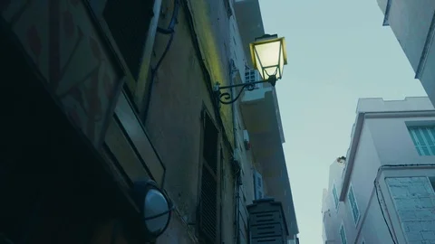 Smooth walking shot tilted up in old street in southern european village Stock Footage 88903436