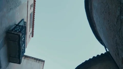 Smooth walking shot tilted up in old street in southern european village Stock Footage 88903438