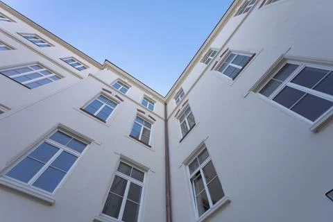 The smooth wall of the building with large windows seen from the very bottom. Stock-Fotos