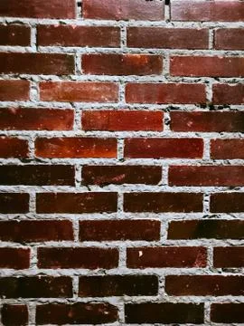 Smooth wall of dark red brick. Red brick wall background. Stock Photos