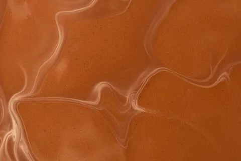 Smooth warm chocolate wave pattern, macro photography Stock Photos