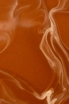 Smooth warm chocolate wave pattern, macro photography Stock Photos