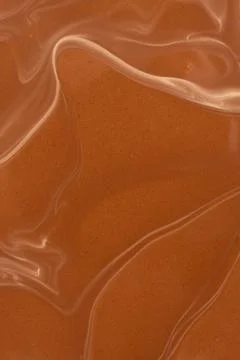 Smooth warm chocolate wave pattern, macro photography Stock Photos