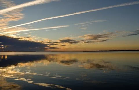 Smooth water at sunset Stock Photos