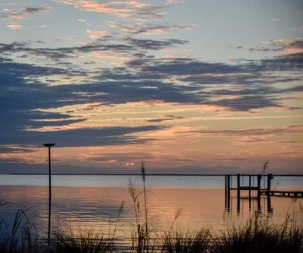 Smooth water at sunset Stock Photos
