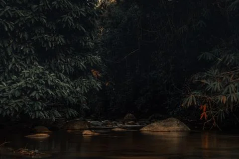 Smooth waterfall on dark-colored rocks Stock Photos