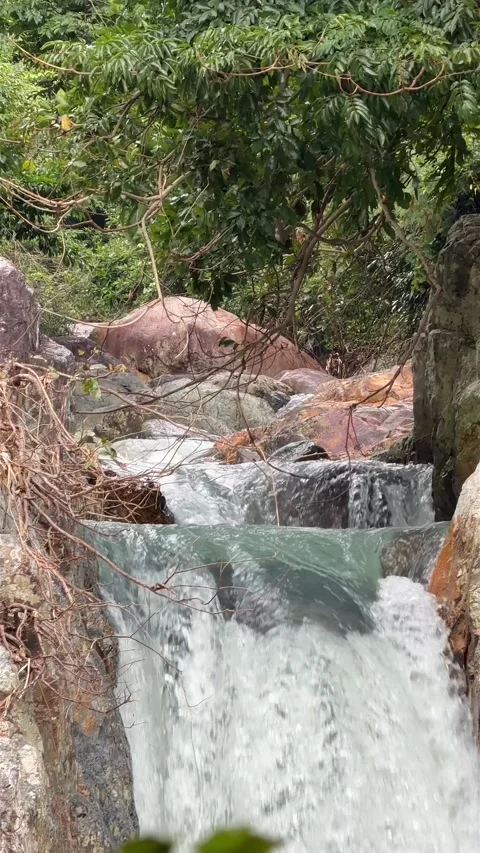 A smooth waterfall flows in close view, slow motion revealing delicate textures Stock Footage 324853480