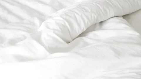 Smooth white bedsheet background, soft texture, clean and minimalist style. Stock Photos