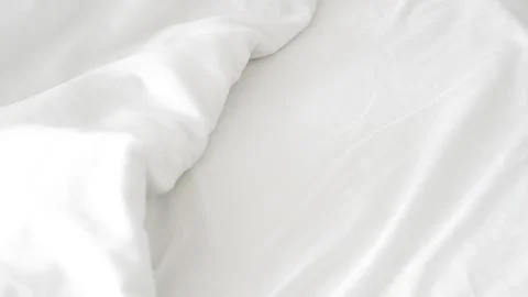 Smooth white bedsheet background, soft texture, clean and minimalist style. Stock Photos
