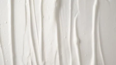 Smooth white cosmetic cream texture scrolling up top view. Vídeos de archivo 341361389