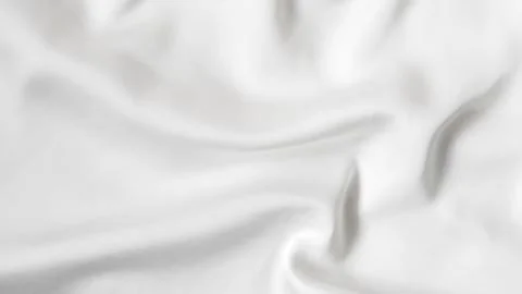 Smooth white silk fabric with soft folds and gentle light reflections. Stock Photos