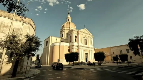 Smooth wide-angle shot moving backward past Chiesa Sant'Agostino in Giovinazzo Stock Footage 315992324