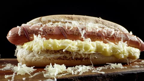 Smooth zoom in from a cheesy appetizing hot dog with a macro lens. Advertising Stock-Footage 139337065