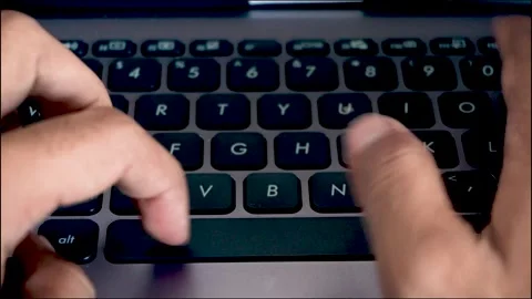 Smooth zoom out movement capturing close up hands typing on a laptop comput.. Stock Footage 340489606
