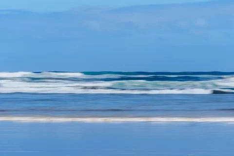 Smoothed surf and shore pattern as waves wash in over wet sand Stock Photos