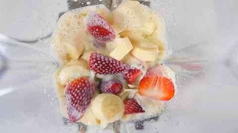 Smoothie blended in slow motion from above using fruit strawberries, bananas  Stock Footage 88516796